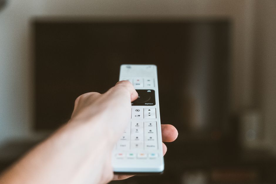 person setting up smart TV at home remote control